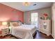 Bright bedroom with white dresser, hardwood floors, and a cozy feel at 3085 Nappa Trl, Stone Mountain, GA 30087