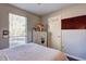 This bedroom features a dresser with a mirror, a TV on the wall, and a large window for natural light at 3085 Nappa Trl, Stone Mountain, GA 30087