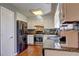 Functional kitchen featuring stainless steel appliances, granite countertops, and hardwood floors at 3085 Nappa Trl, Stone Mountain, GA 30087