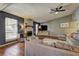 Comfortable living room featuring a fireplace, a sectional sofa, and large windows for natural light at 3085 Nappa Trl, Stone Mountain, GA 30087