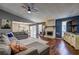 Spacious living room with hardwood floors, a stone fireplace, and a ceiling fan for added comfort at 3085 Nappa Trl, Stone Mountain, GA 30087