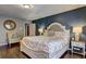 Comfortable main bedroom featuring hardwood floors, decorative lamps, and neutral decor at 3085 Nappa Trl, Stone Mountain, GA 30087