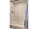 Shower with white subway tile, inset for toiletries, and patterned curtain at 3085 Nappa Trl, Stone Mountain, GA 30087