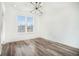 Bright bedroom with modern light fixture and large window for natural light, over hardwood floors at 525 Parkway Ne Dr # 314, Atlanta, GA 30354