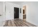 Bright entryway featuring hardwood floors, leading to a bathroom and black front door at 525 Parkway Ne Dr # 314, Atlanta, GA 30354