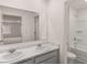 Bathroom features a marble countertop, white cabinets, and a shower and tub combo at 5436 Flat Rock Point Pt, Stonecrest, GA 30038