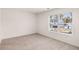 Bright bedroom features neutral carpeting, a large window and white walls at 5436 Flat Rock Point Pt, Stonecrest, GA 30038