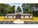 Exterior of a community clubhouse, landscaped, and featuring an arched entrance at 5436 Flat Rock Point Pt, Stonecrest, GA 30038