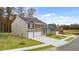 Charming two-story home with a brick and siding exterior, three-car garage and green lawn at 5436 Flat Rock Point Pt, Stonecrest, GA 30038