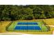 Aerial view of two tennis courts surrounded by a green fence and trees in the background at 5436 Flat Rock Point Pt, Stonecrest, GA 30038