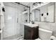 Modern bathroom with sleek vanity, marble walls, and glass shower doors at 215 Piedmont Ne Ave # 1804, Atlanta, GA 30308