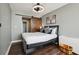 Cozy bedroom with a modern bed frame, wood-style floors, and a rustic sliding barn door at 215 Piedmont Ne Ave # 1804, Atlanta, GA 30308