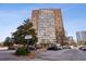 Full building exterior shot of the Landmark Condominiums with the parking lot in the foreground at 215 Piedmont Ne Ave # 1804, Atlanta, GA 30308