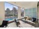 Inviting lounge area with large windows overlooking a pool and lush greenery at 215 Piedmont Ne Ave # 1804, Atlanta, GA 30308