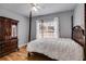 Bedroom with a large, ornate bed and armoire on hardwood flooring at 2175 Ashton Dr, Villa Rica, GA 30180