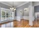 Bright dining room with hardwood floors, chandelier, and classic wall trim at 2175 Ashton Dr, Villa Rica, GA 30180