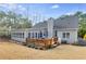 Backyard view of this home, with back deck, sunroom, and neutral exterior at 2175 Ashton Dr, Villa Rica, GA 30180