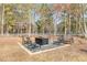 Backyard view of outdoor fire pit with seating area, surrounded by mature trees at 2175 Ashton Dr, Villa Rica, GA 30180