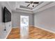 Living room with tray ceilings, hardwood flooring and glass-paneled French doors leading to the sun room at 2175 Ashton Dr, Villa Rica, GA 30180