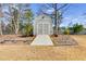 Backyard view of white storage shed with ramp access and landscaping at 2175 Ashton Dr, Villa Rica, GA 30180