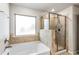 Elegant bathroom featuring a glass-enclosed shower and luxurious tub at 3596 Maple Hill Rd, Lithonia, GA 30038