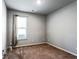 Neutral-toned bedroom featuring a window with blinds and carpeted floor at 3596 Maple Hill Rd, Lithonia, GA 30038