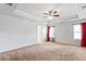 Expansive bedroom with tray ceiling, carpeted floor, and natural light at 3596 Maple Hill Rd, Lithonia, GA 30038