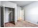 Bedroom with carpeted floor, closet with shelves, and a white door at 3596 Maple Hill Rd, Lithonia, GA 30038