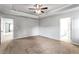 Bedroom with a tray ceiling, carpeted floors, and connecting doors at 3596 Maple Hill Rd, Lithonia, GA 30038