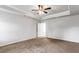 Bedroom with tray ceiling, plush carpeting, and neutral walls at 3596 Maple Hill Rd, Lithonia, GA 30038