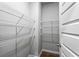 Walk-in closet with white metal shelves and hardwood floor at 3596 Maple Hill Rd, Lithonia, GA 30038