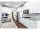 Bright kitchen featuring stainless appliances, granite counters, and white cabinets at 3596 Maple Hill Rd, Lithonia, GA 30038