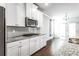 Bright eat-in kitchen featuring white cabinets, granite counters, and hardwood floors at 3596 Maple Hill Rd, Lithonia, GA 30038