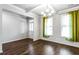 Bright and airy living room with hardwood floors, a decorative chandelier, and green curtains at 3596 Maple Hill Rd, Lithonia, GA 30038