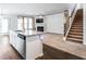 Open-concept kitchen and living room with hardwood floors, fireplace, and ceiling fan at 3596 Maple Hill Rd, Lithonia, GA 30038