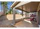 View of the covered patio, showing the lawn and fence in the backyard at 3596 Maple Hill Rd, Lithonia, GA 30038