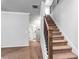 Carpeted stairs with wood handrail leading to upper level of the home at 3596 Maple Hill Rd, Lithonia, GA 30038