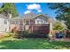 Well-maintained backyard featuring a deck, a lush lawn and cozy blue Adirondack chairs around a fire pit at 949 Park Se Ave, Atlanta, GA 30315