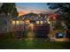 Backyard with string lights, a deck, fire pit, cozy blue Adirondack chairs, and lush greenery at 949 Park Se Ave, Atlanta, GA 30315