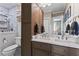 Bathroom showcasing a double vanity with marble countertop, modern fixtures and marble-tiled shower with glass enclosure at 949 Park Se Ave, Atlanta, GA 30315