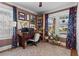 A well-lit office featuring colorful decor, plants, shelving, and a large window overlooking the exterior at 949 Park Se Ave, Atlanta, GA 30315