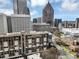 Dynamic city view showcasing various high-rise buildings and landmarks against a blue sky backdrop at 145 15 Ne St # 409, Atlanta, GA 30309