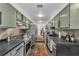 Galley kitchen with gray cabinets, stainless steel appliances, and tiled backsplash at 145 15 Ne St # 409, Atlanta, GA 30309