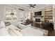 Inviting living room with stone fireplace, built-in shelves, and large windows for natural light at 1986 Forte Ln, Alpharetta, GA 30009