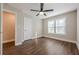 Sunlit bedroom featuring laminate floors, two windows, closet, ceiling fan, and neutral paint at 200 Adeline Nw Ave, Atlanta, GA 30314