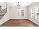 Dining area with wood floors, modern chandelier, and plenty of natural light from the windows at 200 Adeline Nw Ave, Atlanta, GA 30314