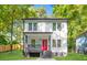 Charming two-story home featuring a vibrant red door, covered porch, and freshly manicured lawn at 200 Adeline Nw Ave, Atlanta, GA 30314