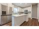 Bright kitchen featuring a stainless steel refrigerator, island, and white cabinetry at 200 Adeline Nw Ave, Atlanta, GA 30314