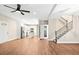 Open-concept living room showcasing modern hardwood flooring, staircase, and a kitchen area at 200 Adeline Nw Ave, Atlanta, GA 30314