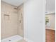 Modern walk-in shower has sleek tile, with a recessed shelf and handheld shower fixture at 200 Adeline Nw Ave, Atlanta, GA 30314